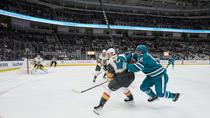 Sep 26, 2025; San Jose, California, USA; San Jose Sharks right wing Ethan Cardwell (56) vies for position against Vegas Golden Knights defenseman Ben Hutton (17) with center Tanner Laczynski (28) and goaltender Akira Schmid (40) during the second period at SAP Center at San Jose. Mandatory Credit: Robert Edwards-Imagn Images