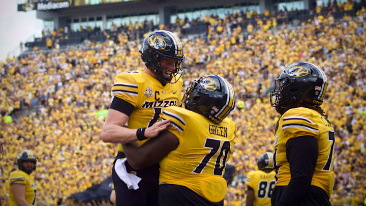 Sep 14, 2024; Columbia, Missouri, USA; Missouri Tigers quarterback Brady Cook (12) celebrates with Tigers offensive lineman Cayden Green (70) following a touchdown against the Boston College Eagles at Faurot Field at Memorial Stadium.