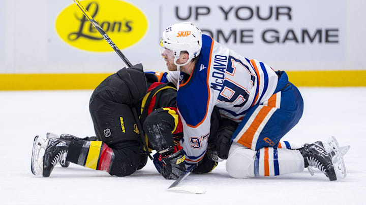 Jan 18, 2025; Vancouver, British Columbia, CAN; Edmonton Oilers forward Connor McDavid (97) battles with Vancouver Canucks forward Conor Garland (8) in the third period at Rogers Arena. Mandatory Credit: Bob Frid-Imagn Images