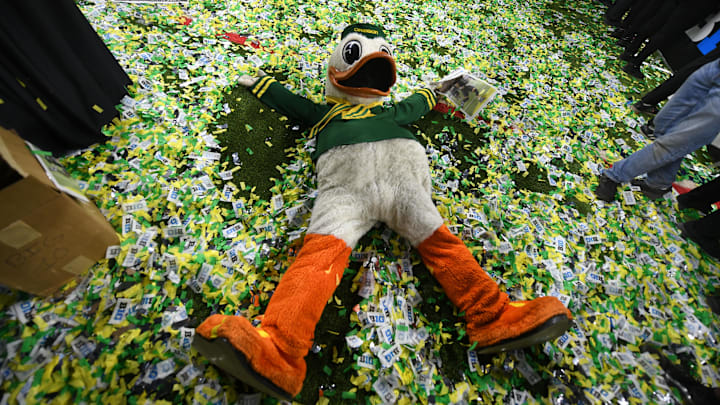 Dec 7, 2024; Indianapolis, IN, USA; The Oregon Duck mascot makes snow angels in confetti after defeating the Penn State Nittany Lions to win the Big Ten Championship in the 2024 Big Ten Championship.