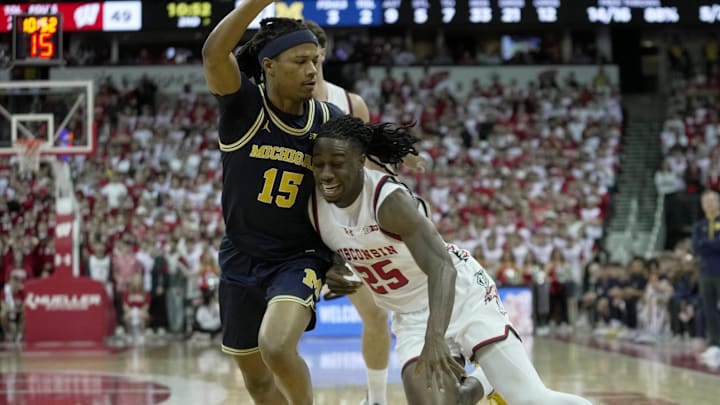 Wisconsin guard John Blackwell (25) runs into Michigan guard Rubin Jones (15) during the second half of their game Tuesday, December 3, 2024 at the Kohl Center in Madison, Wisconsin. Michigan beat Wisconsin 67-64.