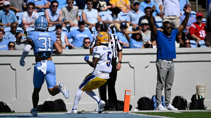 Oct 5, 2024; Chapel Hill, North Carolina, USA; Pittsburgh Panthers wide reciever Raphael Williams (5) scores as North Carolina Tar Heels defensive back Will Hardy (31) defends in the second quarter at Kenan Memorial Stadium. Mandatory Credit: Bob Donnan-Imagn Images