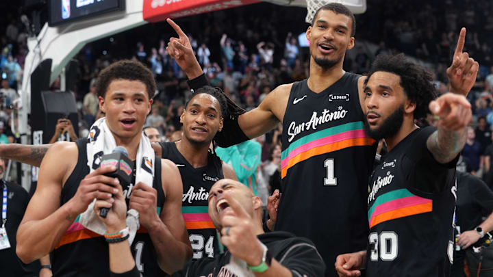 Mar 6, 2026; San Antonio, Texas, USA; San Antonio Spurs forward Victor Wembanyama (1) reacts with teammates forwards Carter Bryant (11) and Julian Champagnie (30) and guard Devin Vassell (24) after securing a comeback victory over the Los Angeles Clippers at Frost Bank Center. Mandatory Credit: Scott Wachter-Imagn Images