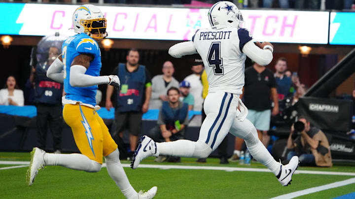 Dallas Cowboys QB Dak Prescott scores on an 18-yard touchdown run against Los Angeles Chargers safety Derwin James Jr.
