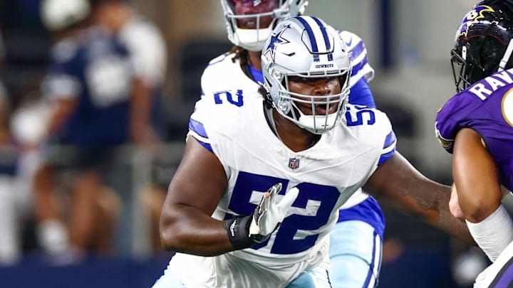 Dallas Cowboys guard Tyler Booker blocks during the first half against the Baltimore Ravens at AT&T Stadium. 