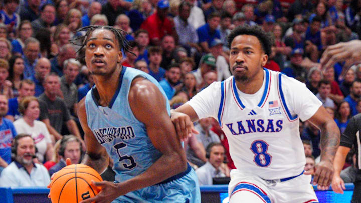 Oct 29, 2024; Lawrence, KS, USA; Washburn Ichabods guard Jacob Hanna (5) goes up for a shot as Kansas Jayhawks guard David Coit (8) defends during the first half at Allen Fieldhouse. Mandatory Credit: Denny Medley-Imagn Images