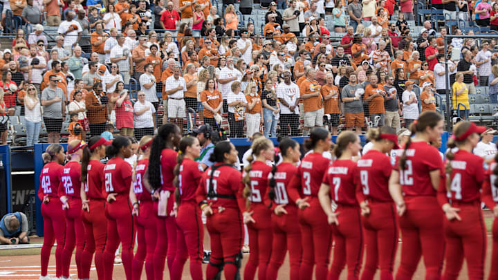 Jun 6, 2025; Oklahoma City, OK, USA; Texas Longhorns fans and Texas Tech Red Raiders players stand for the playing of the National Anthem before game three of the NCAA Softball Women's College World Series finals at Devon Park. Mandatory Credit: Brett Rojo-Imagn Images Jun 6, 2025; Oklahoma City, OK, USA; Texas Longhorns fans and Texas Tech Red Raiders players stand for the playing of the National Anthem before game three of the NCAA Softball Women's College World Series finals at Devon Park. Mandatory Credit: Brett Rojo-Imagn Images