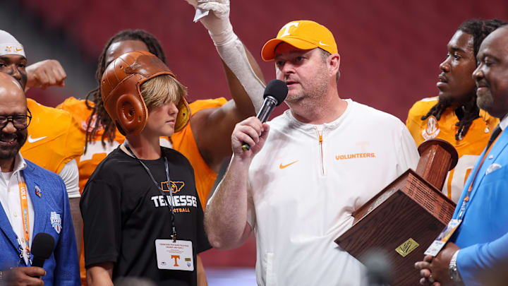 Aug 30, 2025; Atlanta, Georgia, USA; Tennessee Volunteers head coach Josh Heupel celebrates with the old leather helmet after a victory over the Syracuse Orange at Mercedes-Benz Stadium. Mandatory Credit: Brett Davis-Imagn Images
