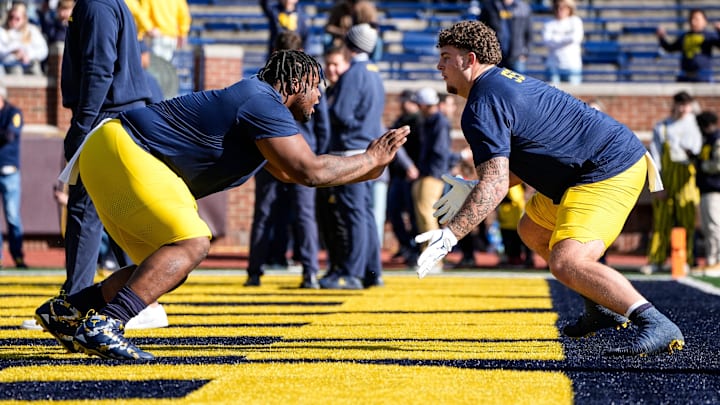 Michigan defensive lineman Kenneth Grant (78), left, warms up with defensive lineman Mason Graham (55) before the Oregon game at Michigan Stadium in Ann Arbor on Saturday, Nov. 2, 2024.