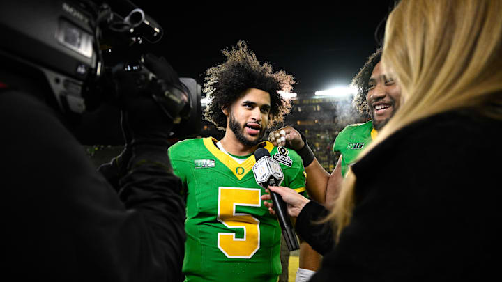Dec 20, 2025; Eugene, OR, USA; Oregon Ducks quarterback Dante Moore (5) is interviewed after the game against the James Madison Dukes at Autzen Stadium. Mandatory Credit: Troy Wayrynen-Imagn Images Dec 20, 2025; Eugene, OR, USA; Oregon Ducks quarterback Dante Moore (5) is interviewed after the game against the James Madison Dukes at Autzen Stadium. Mandatory Credit: Troy Wayrynen-Imagn Images