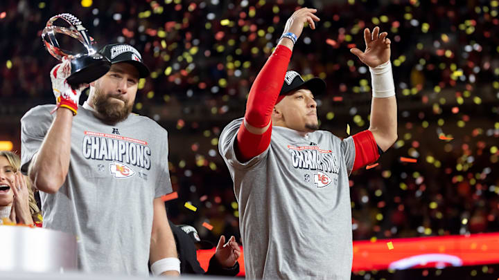 Jan 26, 2025; Kansas City, MO, USA; Confetti falls as Kansas City Chiefs tight end Travis Kelce (left) celebrates with the Lamar Hunt Trophy with quarterback Patrick Mahomes after defeating the Buffalo Bills during the AFC Championship game at GEHA Field at Arrowhead Stadium. Mandatory Credit: Mark J. Rebilas-Imagn Images