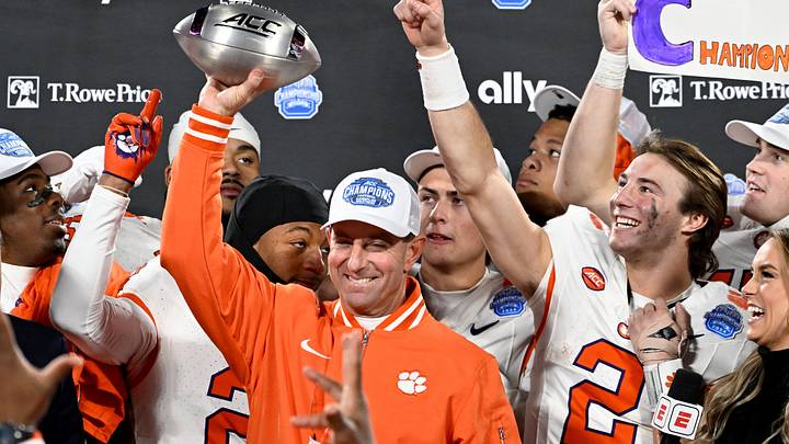 Dec 7, 2024; Charlotte, NC, USA; Clemson Tigers head coach Dabo Swinney, quarterback Cade Klubnik (2) and teammates celebrate after winning the 2024 ACC Championship game against the Southern Methodist Mustangs at Bank of America Stadium. Mandatory Credit: Bob Donnan-Imagn Images Dec 7, 2024; Charlotte, NC, USA; Clemson Tigers head coach Dabo Swinney, quarterback Cade Klubnik (2) and teammates celebrate after winning the 2024 ACC Championship game against the Southern Methodist Mustangs at Bank of America Stadium. Mandatory Credit: Bob Donnan-Imagn Images