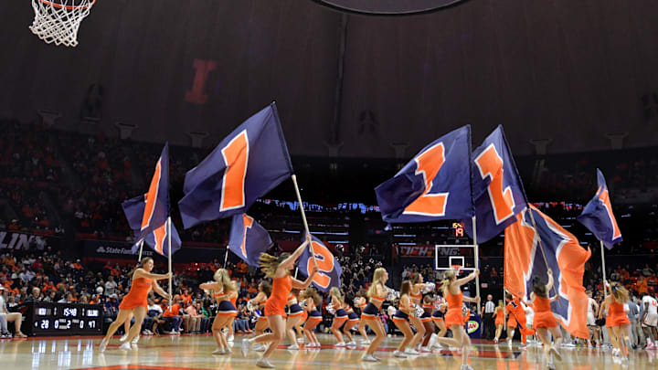 Nov 24, 2023; Champaign, Illinois, USA;  Illinois Fighting Illini cheerleaders perform the running of the flags during the second half against the Western Illinois Leathernecks at State Farm Center. Mandatory Credit: Ron Johnson-Imagn Images