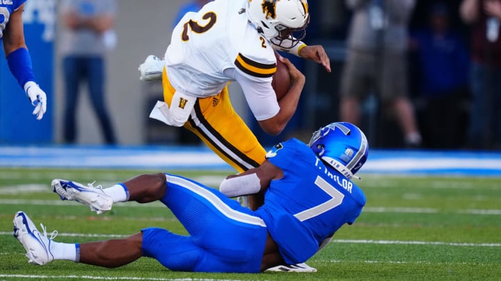 Oct 9, 2021; Colorado Springs, Colorado, USA; Air Force Falcons safety Trey Taylor (7) tackles Wyoming Cowboys quarterback Sean Chambers (2) in the first quarter at Falcon Stadium. Mandatory Credit: Ron Chenoy-USA TODAY Sports