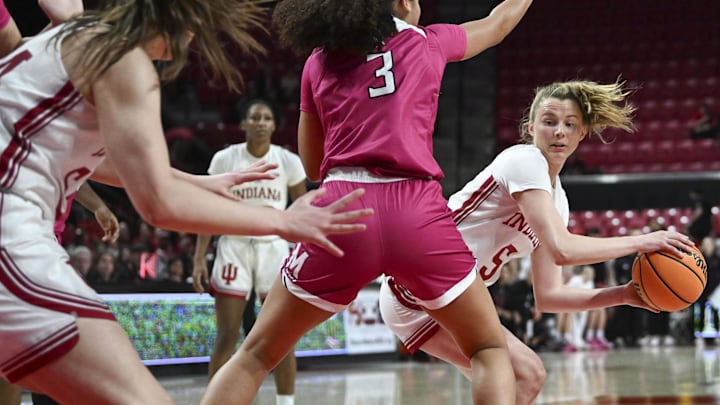 Indiana Hoosiers guard Lenee Beaumont (5) passes around Maryland Terrapins guard Lavender Briggs (3) to forward Mackenzie Holmes (54) during the fist half  at Xfinity Center.