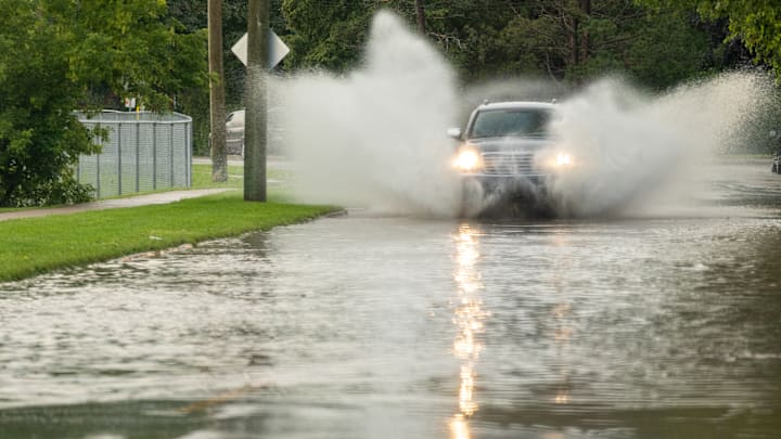 A vehicle makes its way through flooded streets during a recent storm.