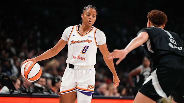 Oct 5, 2025; Las Vegas, Nevada, USA; Phoenix Mercury guard Monique Akoa Makani (8) dribbles the ball against Las Vegas Aces forward Kierstan Bell (1) during the first quarter of game two of the 2025 WNBA Finals at Michelob Ultra Arena. Mandatory Credit: Lucas Peltier-Imagn Images
