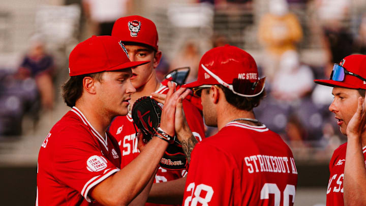 Freshman left-handed pitcher Luke Hemric (far left) high fives his teammates during NC State's 10-3 victory over East Carolina in Greenville, N.C., on April 14, 2026. 