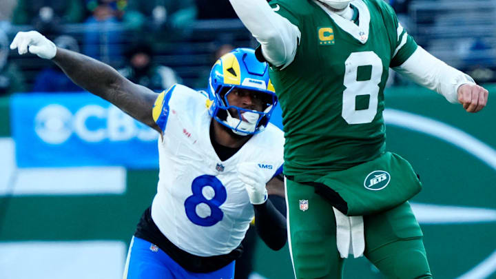 New York Jets quarterback Aaron Rodgers (8) throws a pass beforeLos Angeles Rams linebacker Jared Verse (8) is able to reach hime, Sunday, December 22, 2024, in East Rutherford. New York Jets quarterback Aaron Rodgers (8) throws a pass beforeLos Angeles Rams linebacker Jared Verse (8) is able to reach hime, Sunday, December 22, 2024, in East Rutherford.