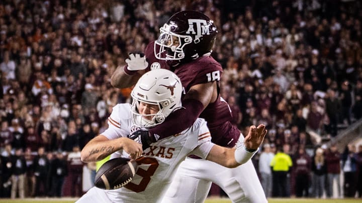 Nov 30, 2024; College Station, Texas, USA; Texas Longhorns quarterback Quinn Ewers (3) is sacked by Texas A&M Aggies defensive lineman Cashius Howell (18) in the third quarter of the Lone Star Showdown at Kyle Field. Mandatory Credit: Sara Diggins/USA TODAY Network via Imagn Images