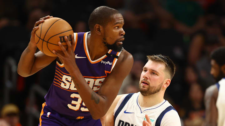 Oct 26, 2024; Phoenix, Arizona, USA; Dallas Mavericks guard Luka Doncic (77) defends against Phoenix Suns forward Kevin Durant (35) in the second half at Footprint Center. Mandatory Credit: Mark J. Rebilas-Imagn Images