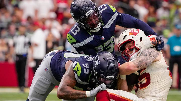 Seattle Seahawks Leonard Williams (99) and Ernest Jones (13) tackle Cardinals tight end Trey McBride (85) during a game at State Farm Stadium in Glendale, Ariz. on Sept. 20, 2026. Seattle Seahawks Leonard Williams (99) and Ernest Jones (13) tackle Cardinals tight end Trey McBride (85) during a game at State Farm Stadium in Glendale, Ariz. on Sept. 20, 2026.