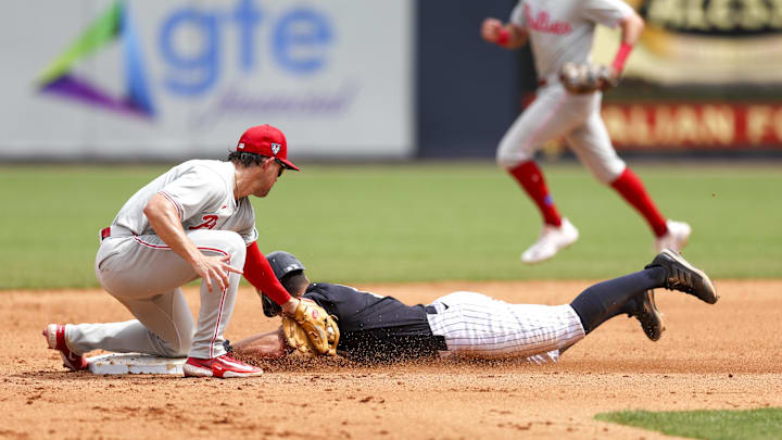 Mar 18, 2024; Tampa, Florida, USA;  New York Yankees shortstop Anthony Volpe (11) is caught stealing second base by Philadelphia Phillies shortstop Scott Kingery (4) in the fifth inning at George M. Steinbrenner Field. Mandatory Credit: Nathan Ray Seebeck-Imagn Images