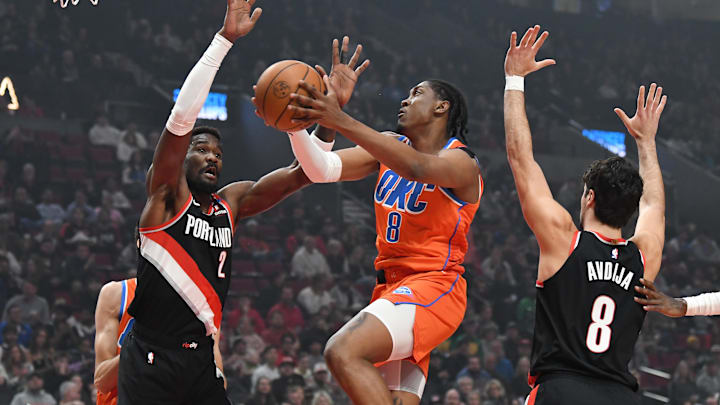Nov 1, 2024; Portland, Oregon, USA; Oklahoma City Thunder forward Jalen Williams (8) drives to the basket against Portland Trailblazers center Deandre Ayton (2) and forward Deni Avdija (8) during the first quarter at Moda Center. Mandatory Credit: Brian Murphy-Imagn Images
