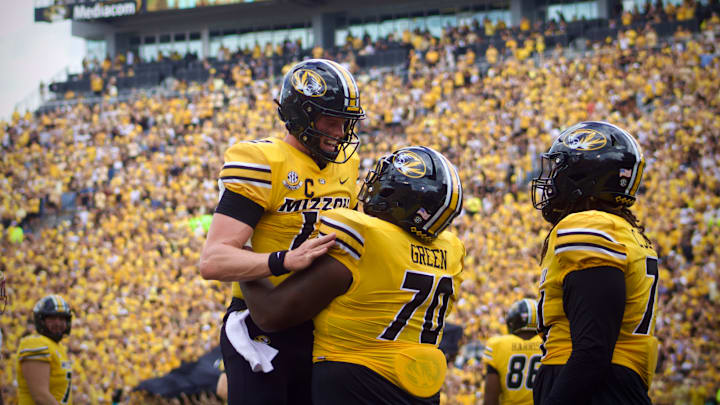 Sep 14, 2024; Columbia, Missouri, USA; Missouri Tigers quarterback Brady Cook (12) celebrates with Tigers offensive lineman Cayden Green (70) following a touchdown against the Boston College Eagles at Faurot Field at Memorial Stadium.