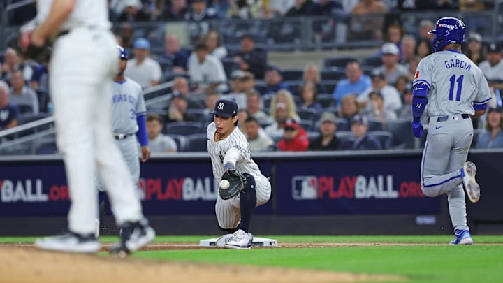 Oct 5, 2024; Bronx, New York, USA; Kansas City Royals third baseman Maikel Garcia (11) runs out a ground ball as New York Yankees first baseman Oswaldo Cabrera (95) receives a throw in the third inning during Game 1 of the ALDS in the 2024 MLB Playoffs at Yankee Stadium.