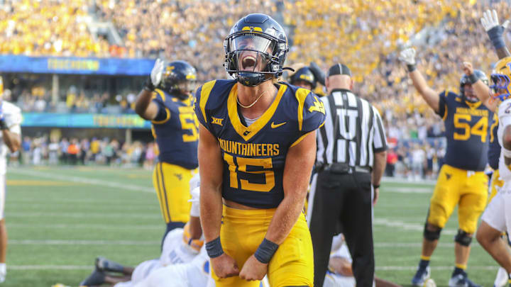 Sep 13, 2025; Morgantown, West Virginia, USA; West Virginia Mountaineers quarterback Scotty Fox Jr. (15) celebrates after a touchdown during the third quarter against the Pittsburgh Panthers at Milan Puskar Stadium. Mandatory Credit: Ben Queen-Imagn Images