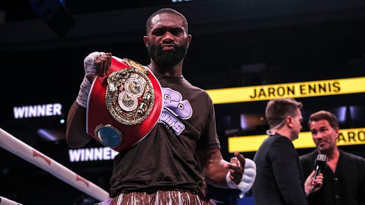 Jaron Ennis (33-0 purple) poses with his belt after defending his championship against challenger Karen Chukhadzhian.