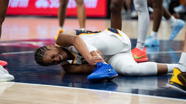 Sep 24, 2026; Minneapolis, Minnesota, USA;  Indiana Fever guard Tyasha Harris (52) holds her leg in the second half against the Minnesota Lynx at Target Center.  Mandatory Credit: Jesse Johnson-Imagn Images