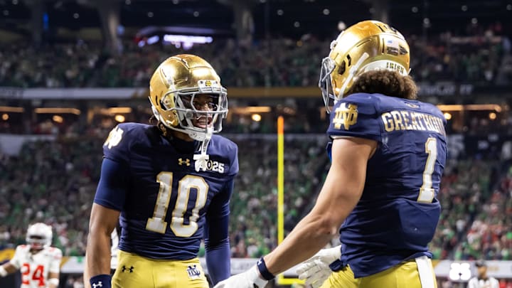 Jan 20, 2025; Atlanta, GA, USA; Notre Dame Fighting Irish wide receiver Jaden Greathouse (1) celebrates a touchdown with teammate Kris Mitchell (10) against the Ohio State Buckeyes during the CFP National Championship college football game at Mercedes-Benz Stadium. Mandatory Credit: Mark J. Rebilas-Imagn Images