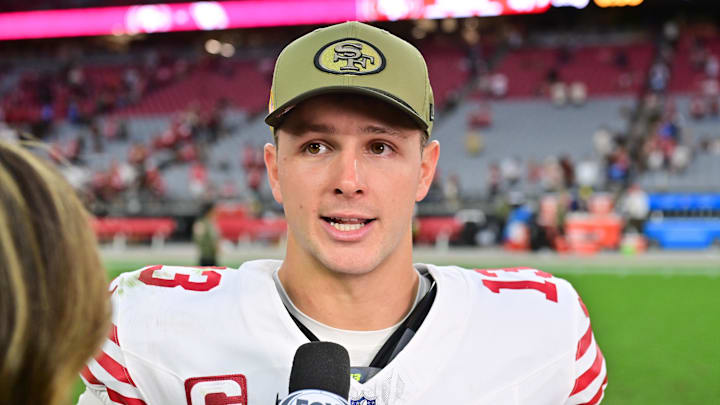 Nov 16, 2025; Glendale, Arizona, USA; San Francisco 49ers quarterback Brock Purdy (13) is interviewed after the game against the Arizona Cardinals at State Farm Stadium. Mandatory Credit: Matt Kartozian-Imagn Images
