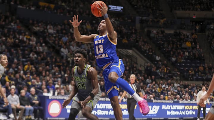 Jan 31, 2026; Morgantown, West Virginia, USA; West Virginia Mountaineers guard Chance Moore (13) makes a move in the lane and shoots during the second half against the Baylor Bears at Hope Coliseum. Mandatory Credit: Ben Queen-Imagn Images