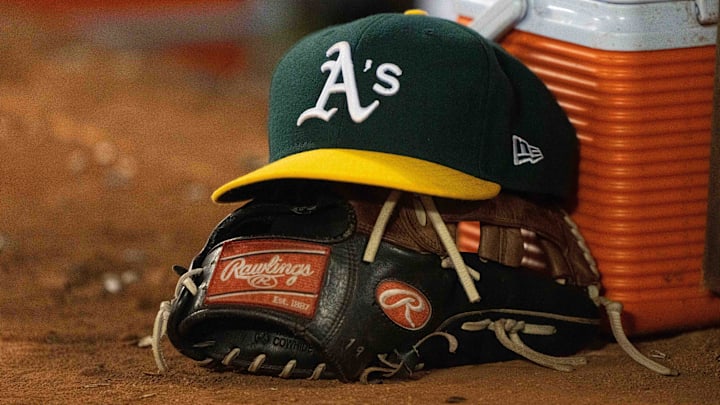  General view of the Athletics cap and glove during the seventh inning against the Boston Red Sox at Oakland-Alameda County Coliseum. 