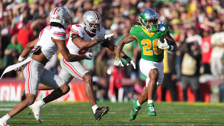 Jan 1, 2025; Pasadena, CA, USA; Oregon Ducks running back Jordan James (20) runs against Ohio State Buckeyes safety Sonny Styles (6) in the first half in the 2025 Rose Bowl college football quarterfinal game at Rose Bowl Stadium. Mandatory Credit: Kirby Lee-Imagn Images