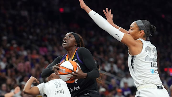 Oct 10, 2025; Phoenix, Arizona, USA; Phoenix Mercury guard Kahleah Copper (2) drives against Las Vegas Aces guard Dana Evans (11) and Las Vegas Aces center A'ja Wilson (22) during the second half of game four of the 2025 WNBA Finals at Mortgage Matchup Center. Mandatory Credit: Joe Camporeale-Imagn Images