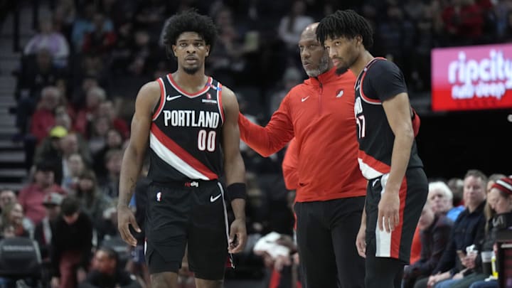 Jan 14, 2025; Portland, Oregon, USA; Portland Trail Blazers head coach Chauncey Billups talks to Scoot Henderson (00) and Shaedon Sharpe (17) during the first half against the Brooklyn Nets at Moda Center. Mandatory Credit: Soobum Im-Imagn Images