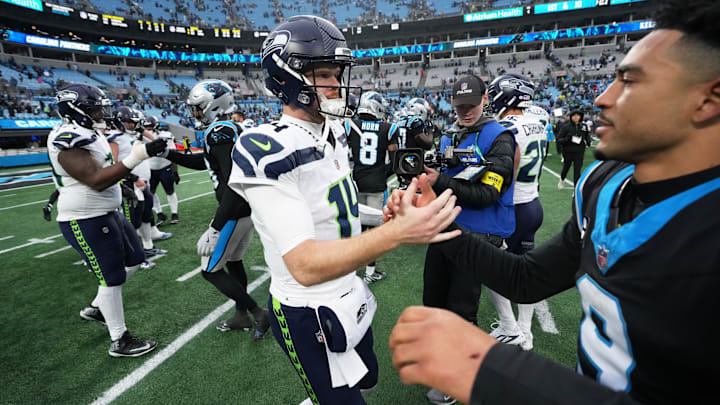 Dec 28, 2025; Charlotte, North Carolina, USA; Seattle Seahawks quarterback Sam Darnold (14) shakes hands with Carolina Panthers quarterback Bryce Young (9) after the game at Bank of America Stadium. 