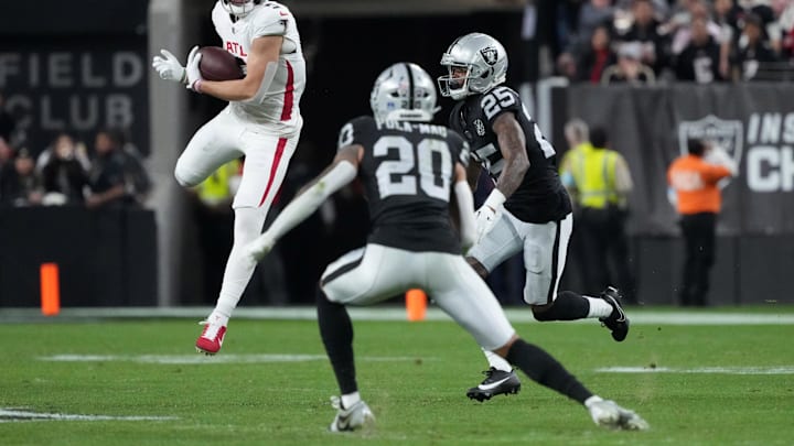 Dec 16, 2024; Paradise, Nevada, USA; Atlanta Falcons wide receiver Drake London (5) catches the ball against Las Vegas Raiders safety Isaiah Pola-Mao (20) and cornerback Decamerion Richardson (25) in the first half at Allegiant Stadium. Mandatory Credit: Kirby Lee-Imagn Images