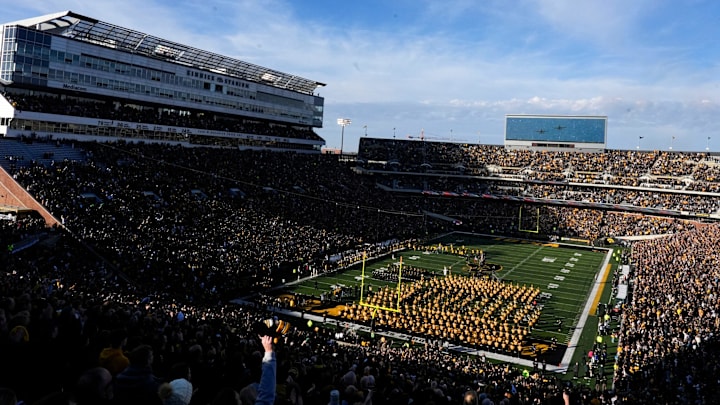 Iowa Hawkeyes fans watch a military flyover at Kinnick Stadium