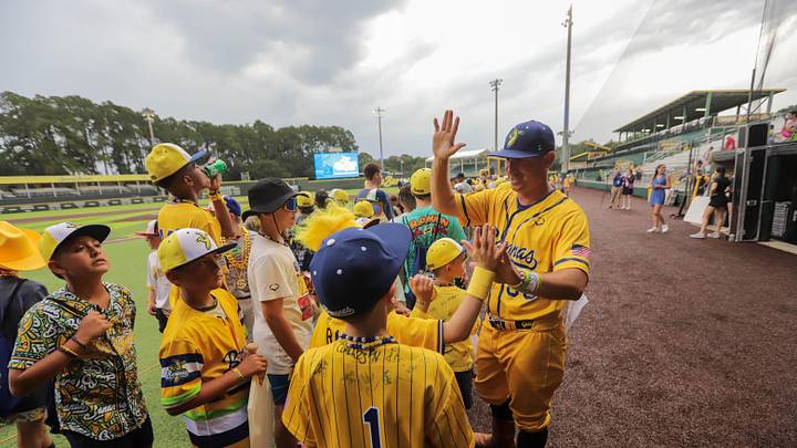 Savannah Bananas coach Tyler Gillum greets players during the opening ceremony for the Banana Ball Youth Tournament on Wednesday, July 9, 2025 at Historic Grayson Stadium in Savannah.