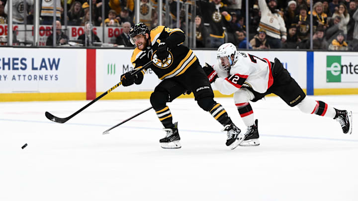 Jan 23, 2025; Boston, Massachusetts, USA; Boston Bruins right wing David Pastrnak (88) shoots and scores Ottawa Senators defenseman Thomas Chabot (72) during the third period at the TD Garden. Mandatory Credit: Brian Fluharty-Imagn Images