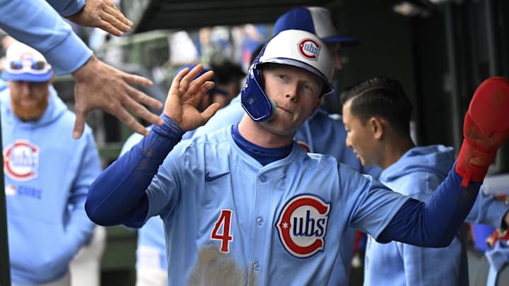 Apr 5, 2025; Chicago, Illinois, USA;  Chicago Cubs outfielder Pete Crow-Armstrong (4) celebrates in the dugout after scoring during the second inning against the San Diego Padres at Wrigley Field.
