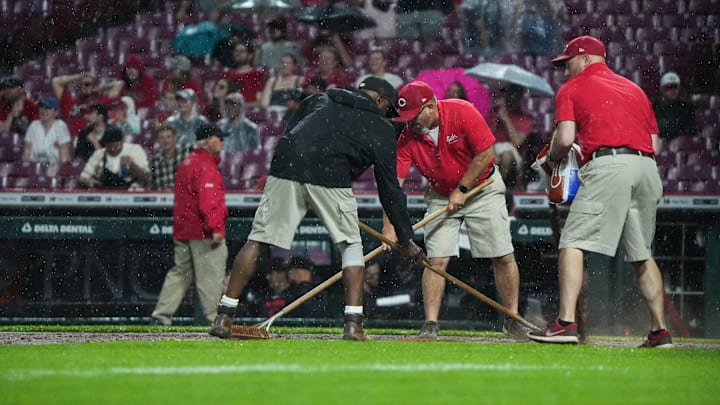 Jun 6, 2025; Cincinnati, OH, USA; Staff works to keep the game going despite the rain during the Reds vs. Diamondbacks game at Great American Ball Park on Friday June 6, 2025. Mandatory Credit: Phil Didion-USA TODAY Network via Imagn Images Jun 6, 2025; Cincinnati, OH, USA; Staff works to keep the game going despite the rain during the Reds vs. Diamondbacks game at Great American Ball Park on Friday June 6, 2025. Mandatory Credit: Phil Didion-USA TODAY Network via Imagn Images
