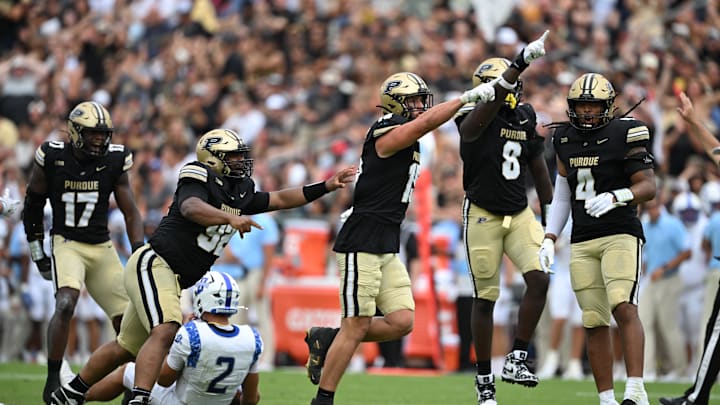 Aug 31, 2024; West Lafayette, Indiana, USA; Purdue Boilermakers defensive end Will Heldt (15) and defensive end CJ Madden (8) celebrate sacking Indiana State Sycamores quarterback Elijah Owens (2) during the second half at Ross-Ade Stadium. Mandatory Credit: Marc Lebryk-Imagn Images