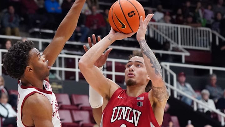 Dec 7, 2025; Stanford, California, USA;  UNLV Runnin' Rebels guard Dra Gibbs-Lawhorn (0) shoots against Stanford Cardinal guard Ebuka Okorie (1) in the second half at Maples Pavilion. Mandatory Credit: David Gonzales-Imagn Images