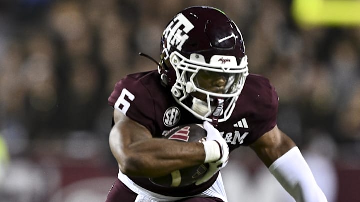 Nov 16, 2024; College Station, Texas, USA; Texas A&M Aggies wide receiver Cyrus Allen (6) attempts to break a tackle from New Mexico State Aggies safety Tayden Barnes (3) during the first half at Kyle Field. Mandatory Credit: Maria Lysaker-Imagn Images 